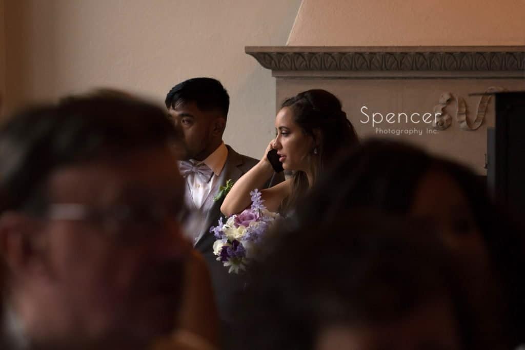 bride talking on phone at Ariel Pearl wedding reception