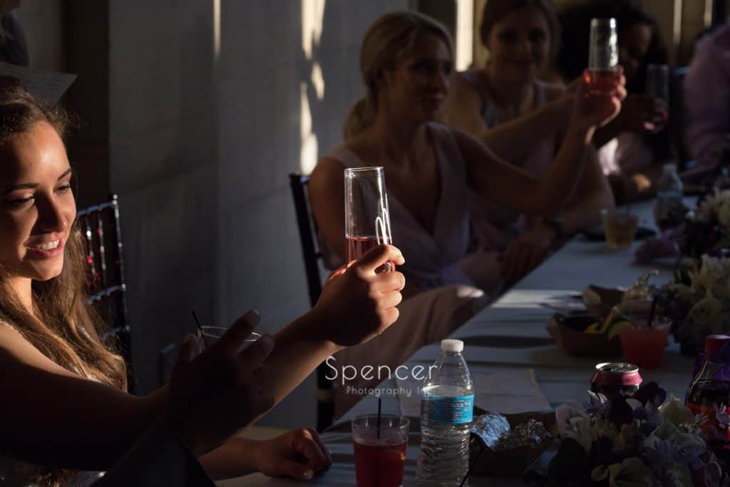 bride toasting at her wedding reception at Ariel Pearl