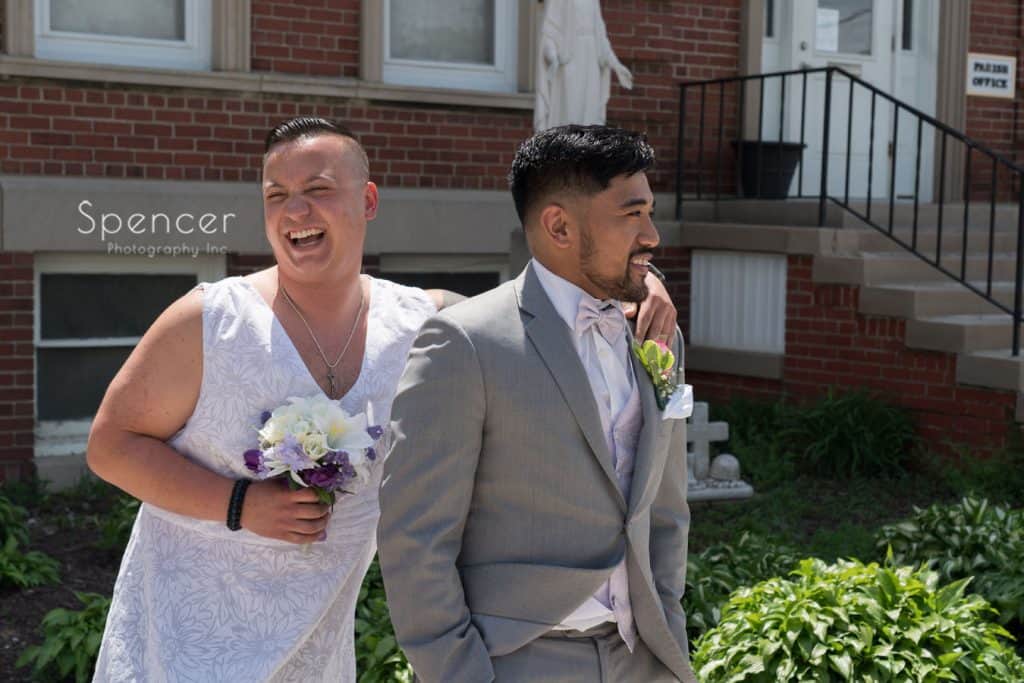 best man and groom laughing