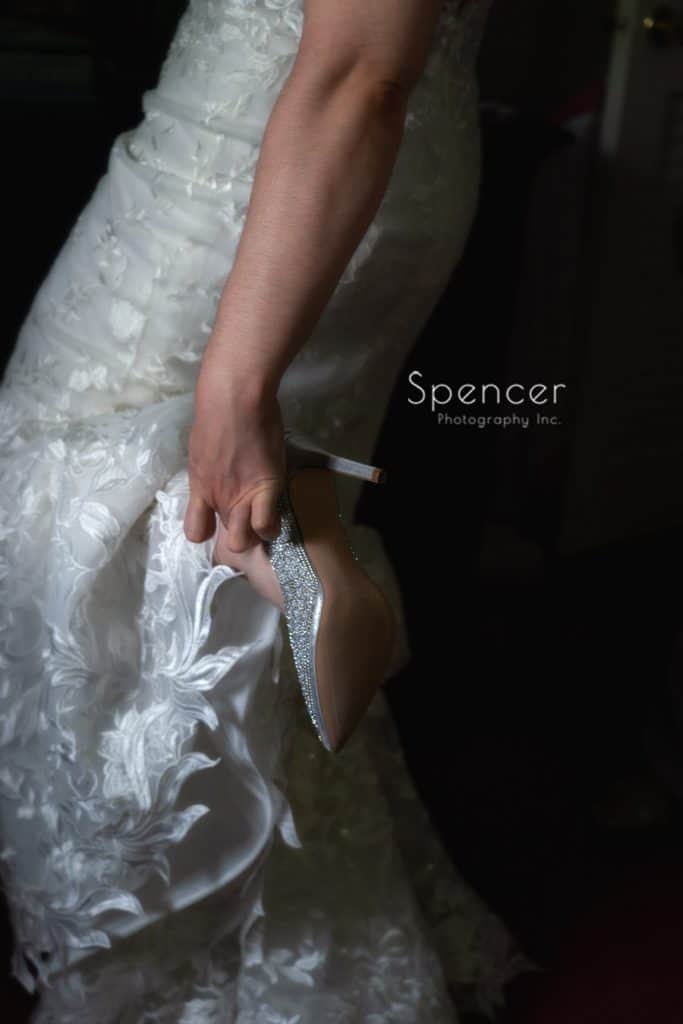  bride putting on her wedding shoes