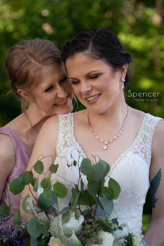 bride laughing with the maid of honor atColumbia Hills Country Club