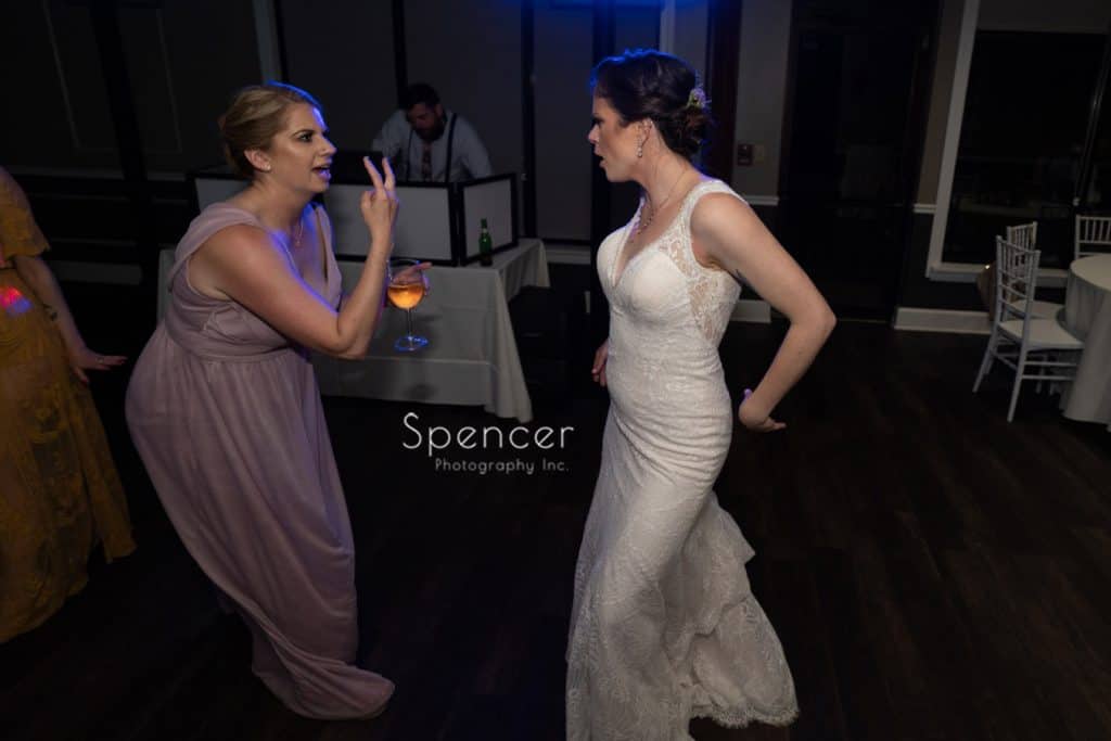 bride dancing with bridesmaid at her wedding reception at Columbia Hills