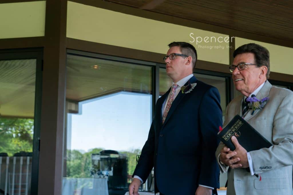 groom and pastor walking aisle at wedding Columbia Hills Country Club