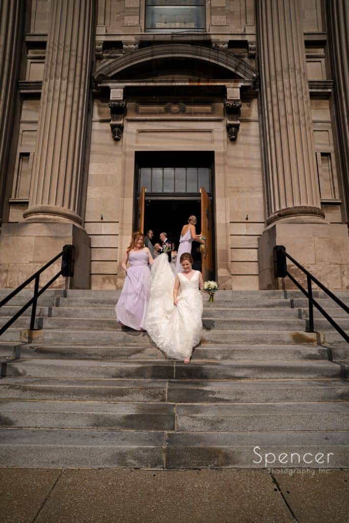  bride leaving wedding ceremony at St. Coleman Church