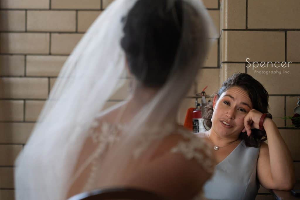  maid of honor talking with bride before wedding ceremony at St. Demetrios
