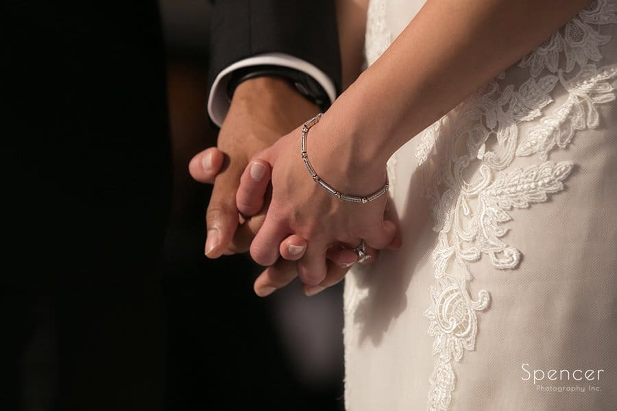 bride and groom holding hands at wedding ceremony at Landerhaven