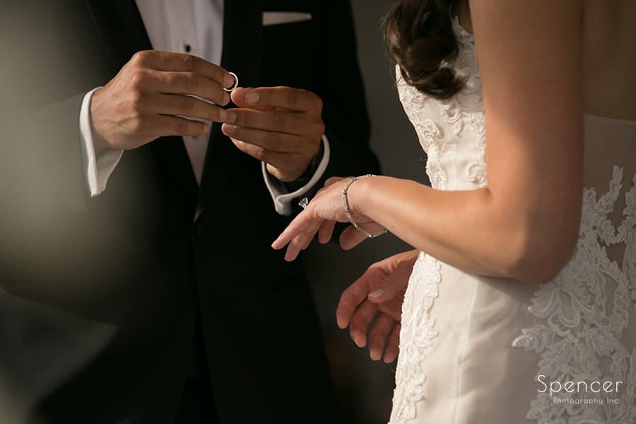 groom holding wedding ring