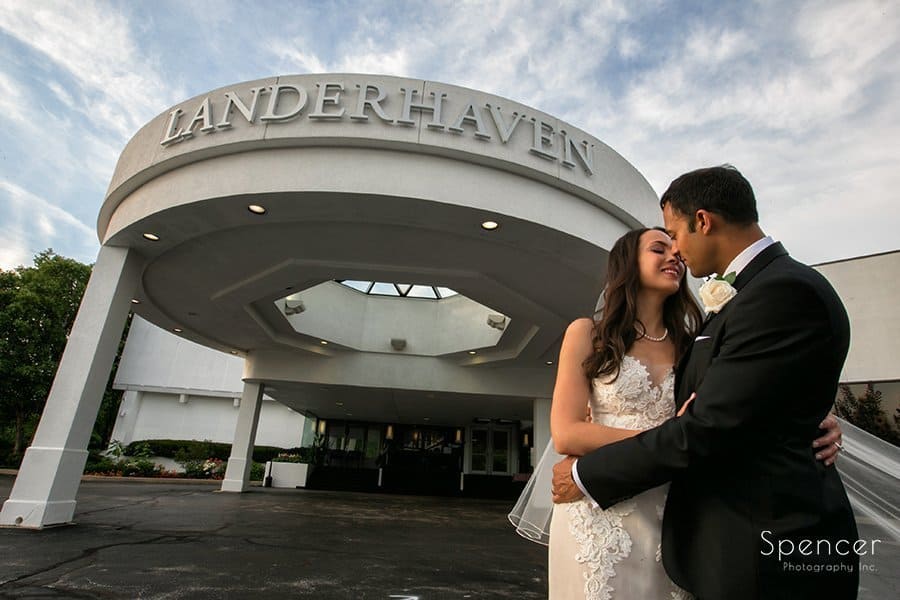 bride and groom kissing in front of Landerhaven after their wedding