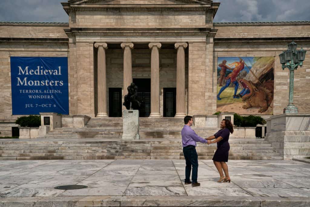 couple dancing during engagement pictures in front of Cleveland Museum of Art