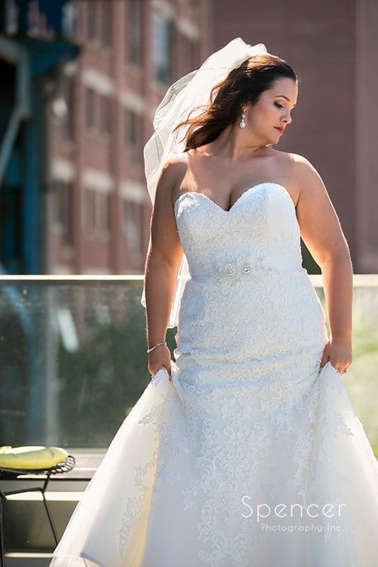creative wedding picture of bride outside of Aloft Cleveland hotel