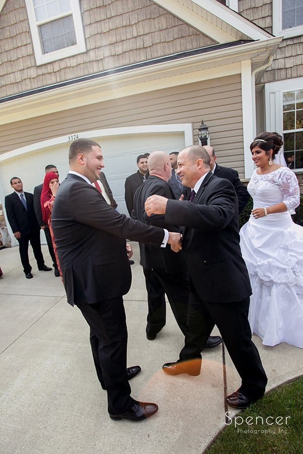 father of bride greets groom at Muslim wedding