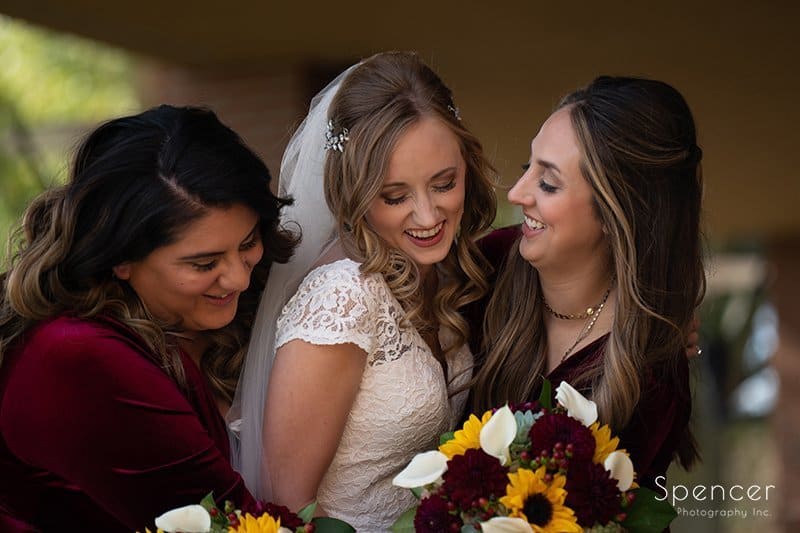 bride laughing with bridesmaids at firestone country club wedding