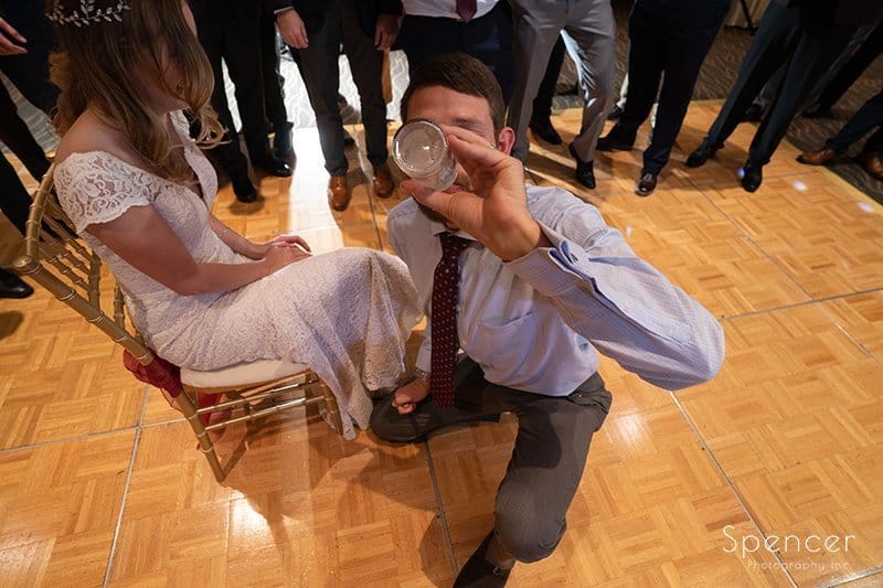  groom chugs drink during garter removal at Firestone