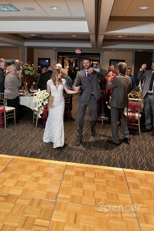 bride and groom enter their wedding reception at Firestone