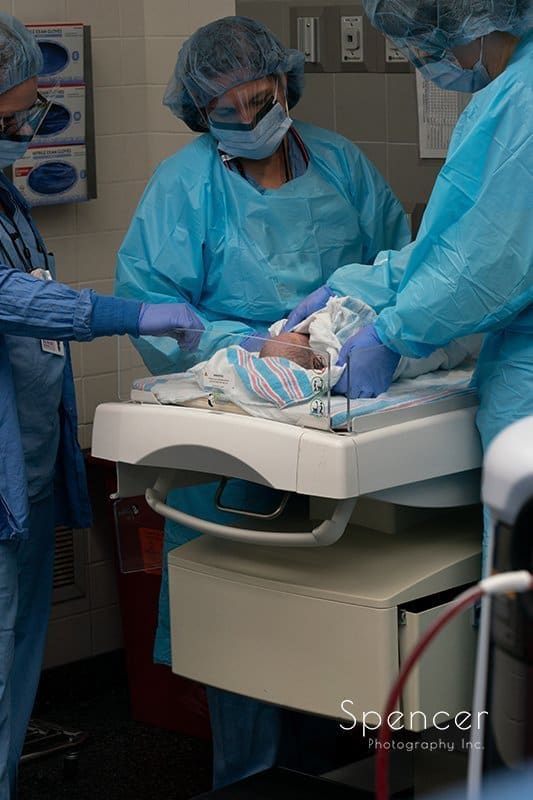 nurses cleaning up baby after delivery :: birth photography