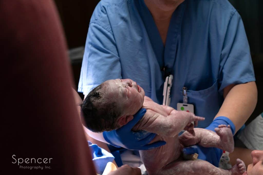 baby being cleaned after being born in Akron City Hospital