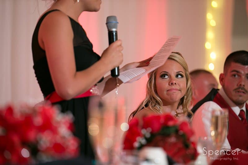 bride listening to maid of honor speech during wedding reception in Strongsville