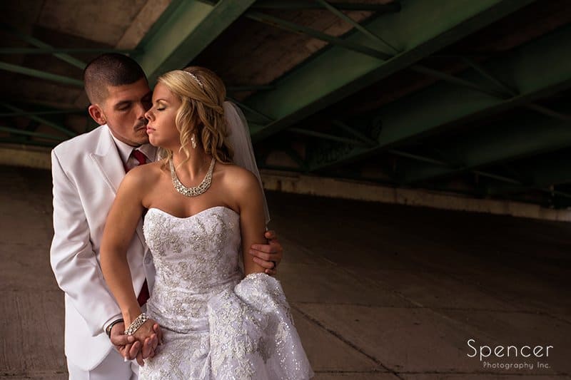 bride and groom kissing under bridge in Strongsville Ohio