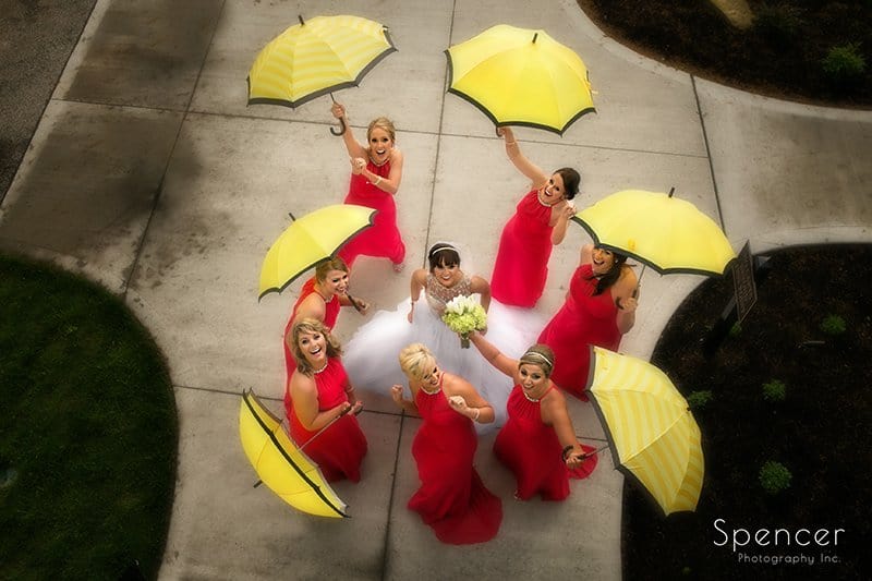 bridesmaids lauging with umbrellas in wedding picture at Firestone