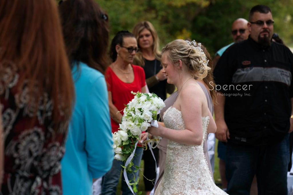 bride walking past wedding guests