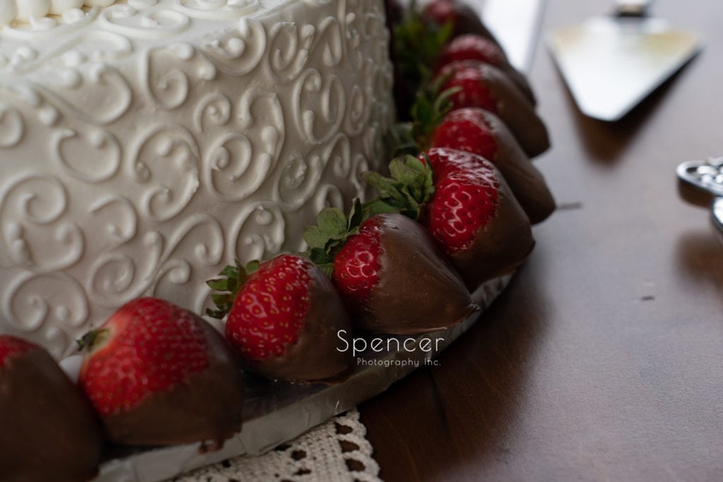 strawberries on wedding cake at wedding reception in merriman valley