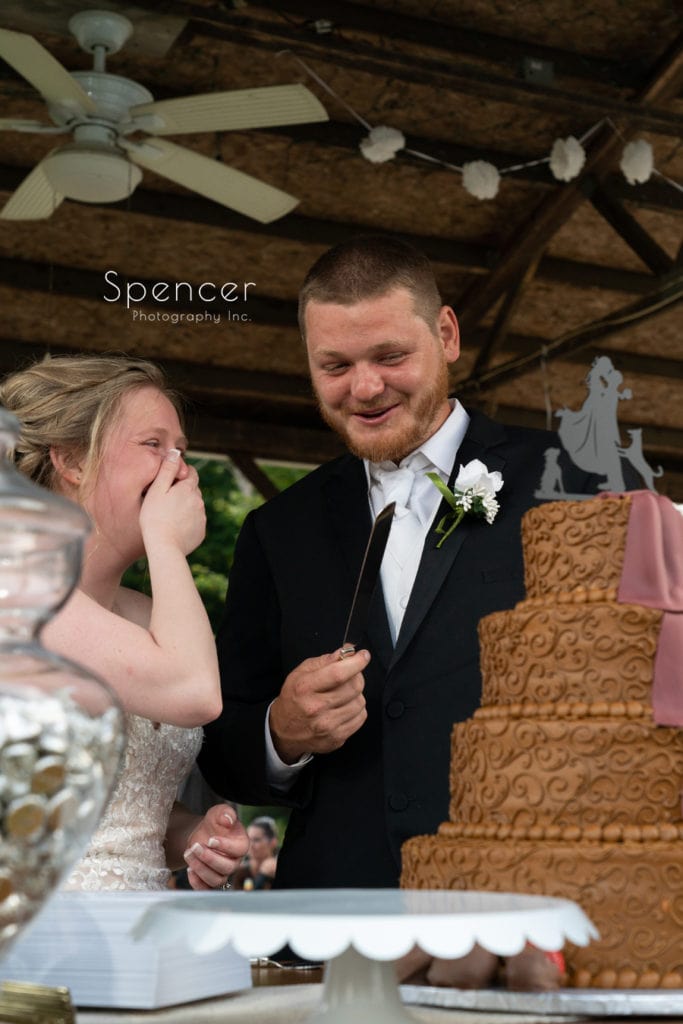  bride and groom cutting their wedding cake
