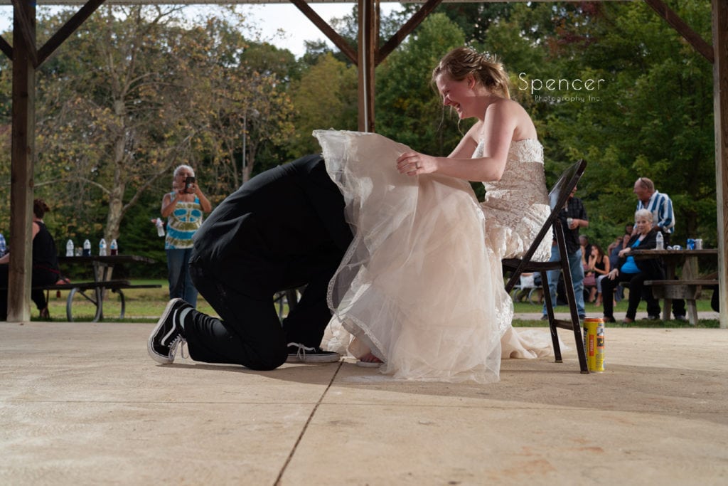 groom removing bridal garter