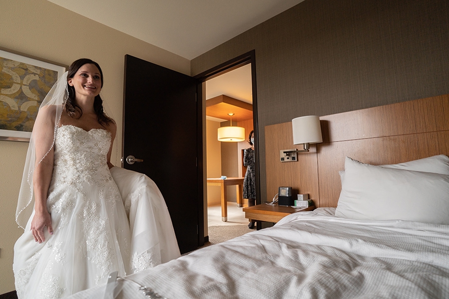 bride looking at her wedding dress in room at Hyatt Place Cleveland