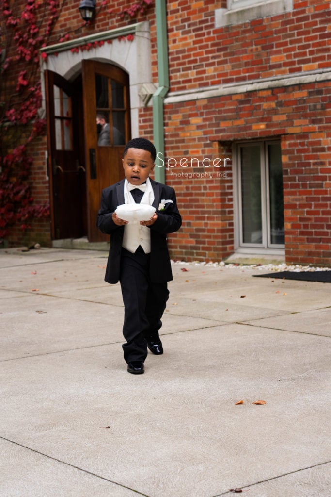 ring bearer walking to ceremony at Glenmoor Country Club