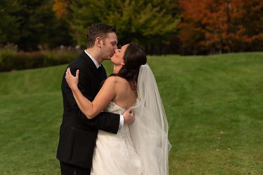 groom kissing bride before wedding at Stonewater
