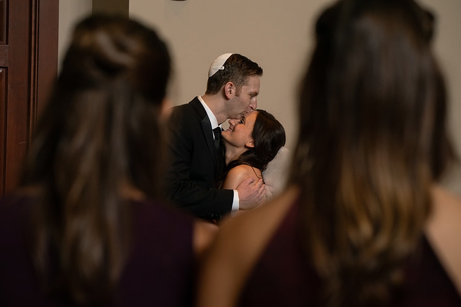 groom kissing bride at ketubah signing at Jewish wedding in Cleveland