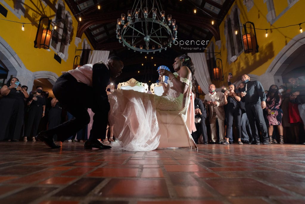 groom removing wedding garter from bride at Glenmoor