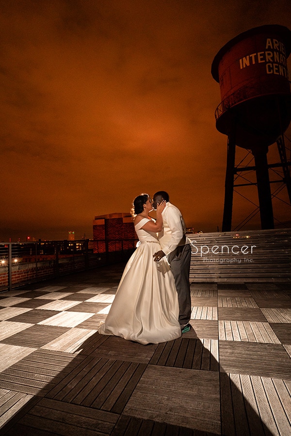 bride kissing groom on roof of Ariel International Cleveland