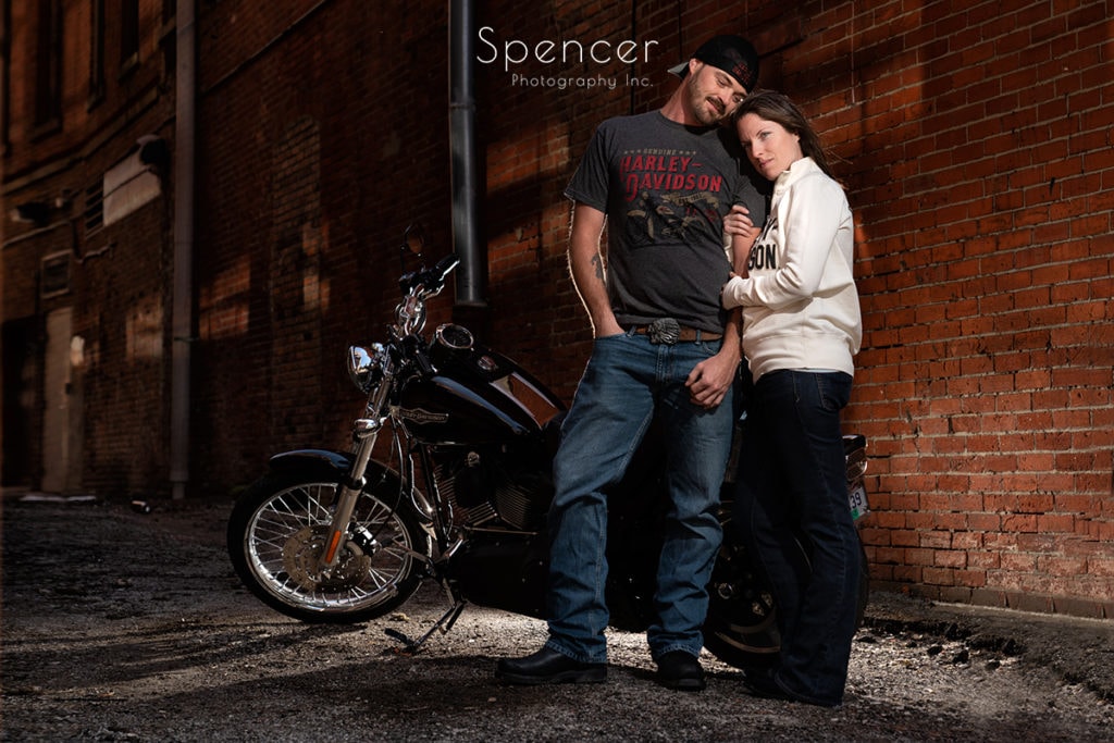 couple hugging in the engagement session in Cleveland with a motorcycle