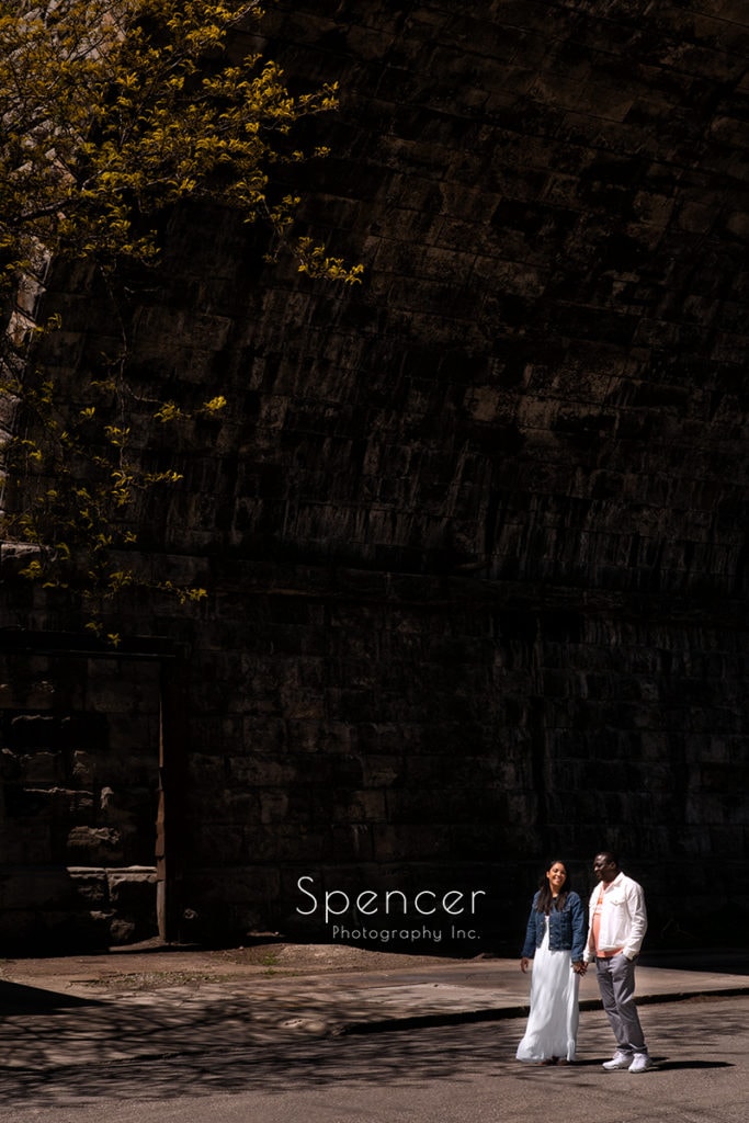 couple walking in their engagement pictures in Cleveland east bank