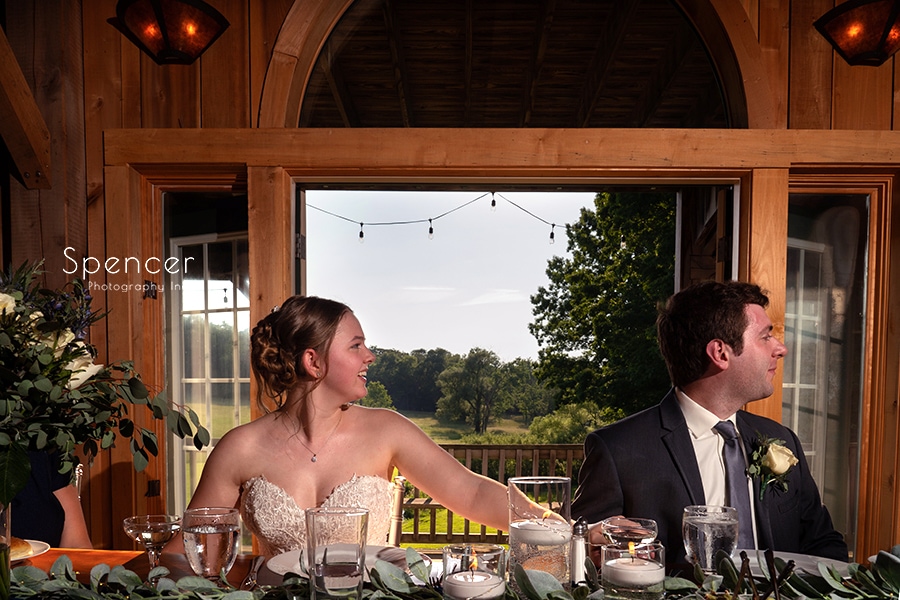 bride and groom listening to maid of honor speech at Crystal Brook Farm