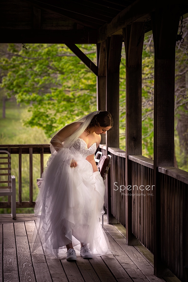 bride adjusting her dress on deck at Crystal Brook Farm