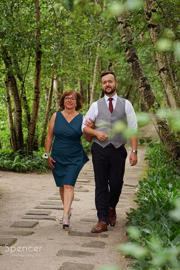 mom and groom walking birch alley at stan hywet wedding