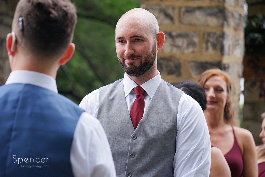 groom smiling at groom during same sex wedding at stan hywet