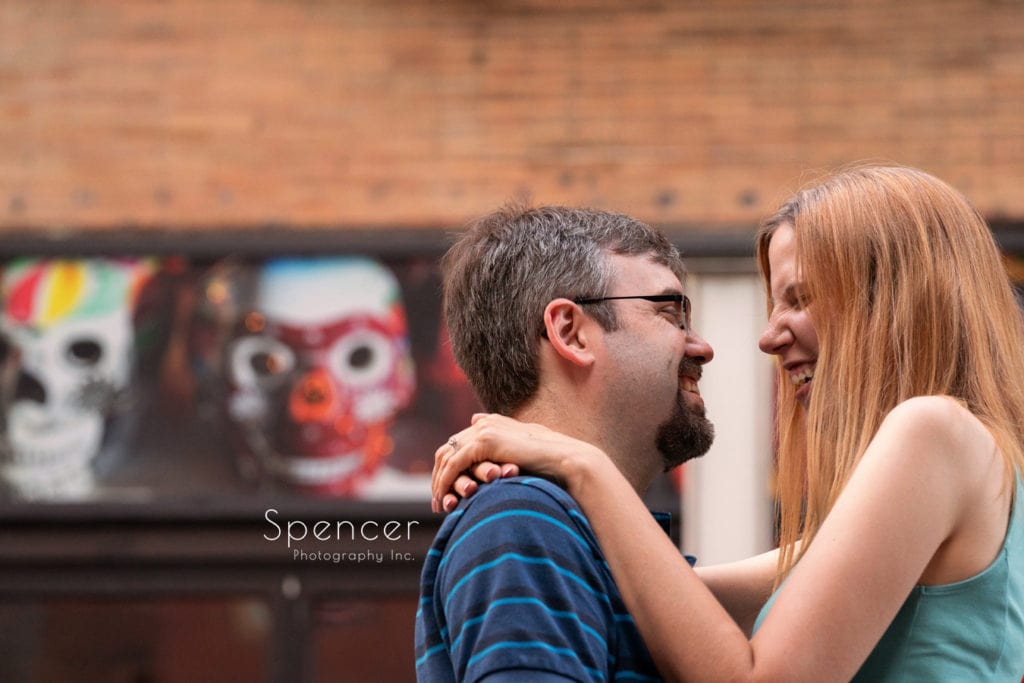 couple laughing during engagement pictures in Cleveland