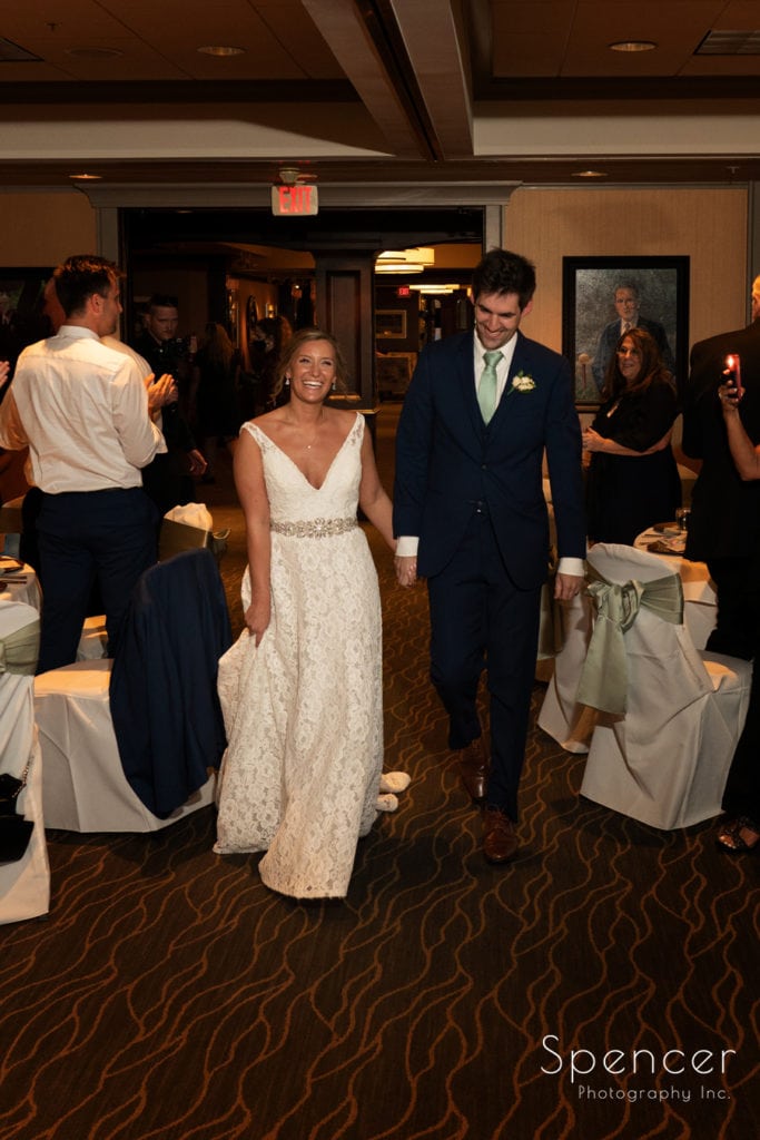 bride and groom enter their wedding reception at Firestone