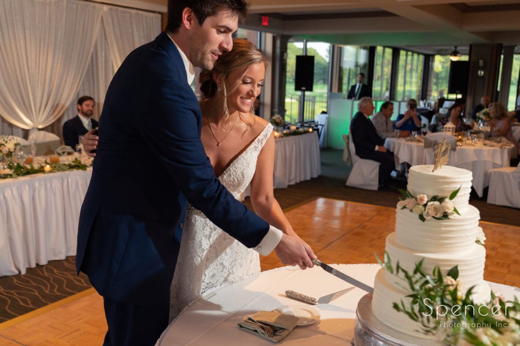 bride and groom cutting wedding cake at Firestone reception