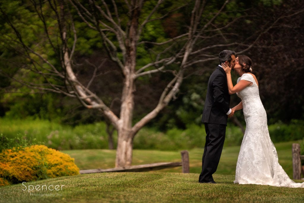 bride and groom kissing at wedding at Patterson Fruit Farm