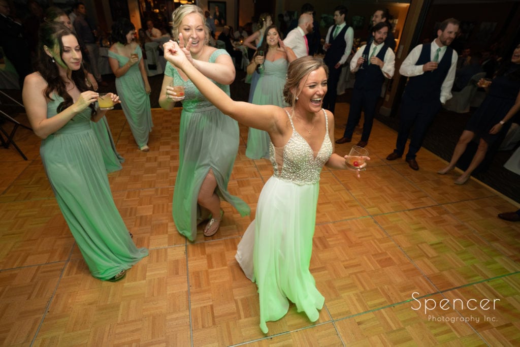 bride laughing while dancing with maid of honor