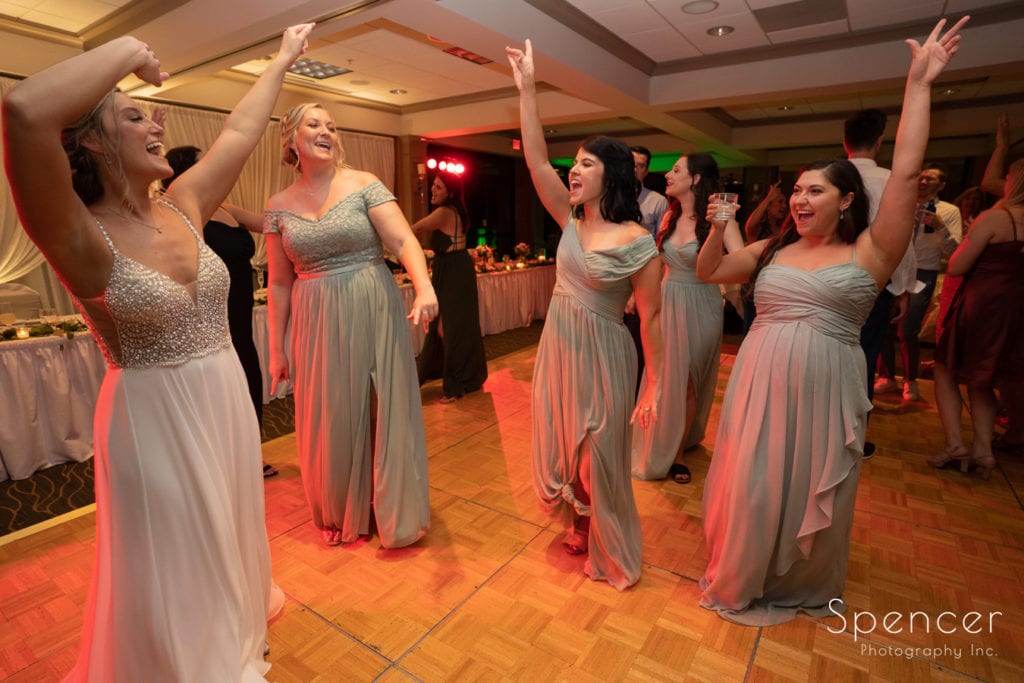 bride waving arms on dance floor
