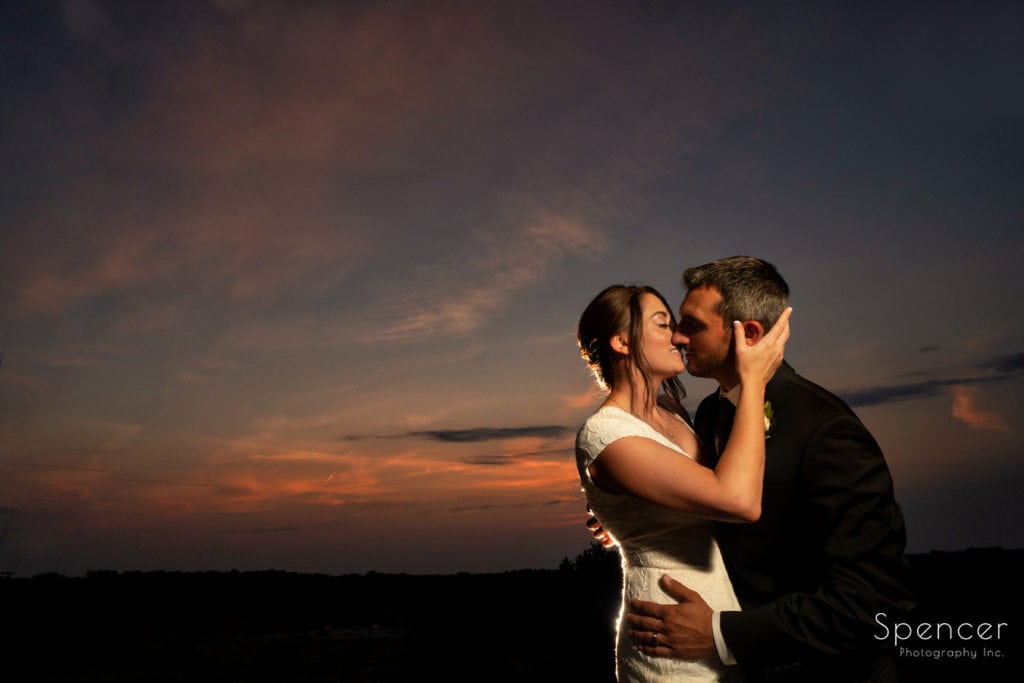 bride kissing groom after wedding at Patterson Fruit Farm
