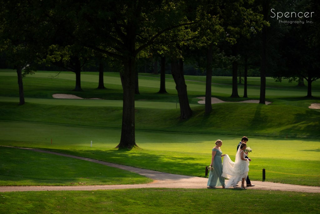  bride and groom walking on golf course at Firestone