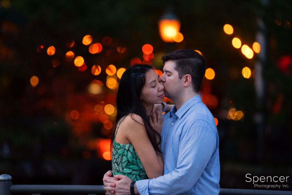 man kissing woman in engagement pics in NYC