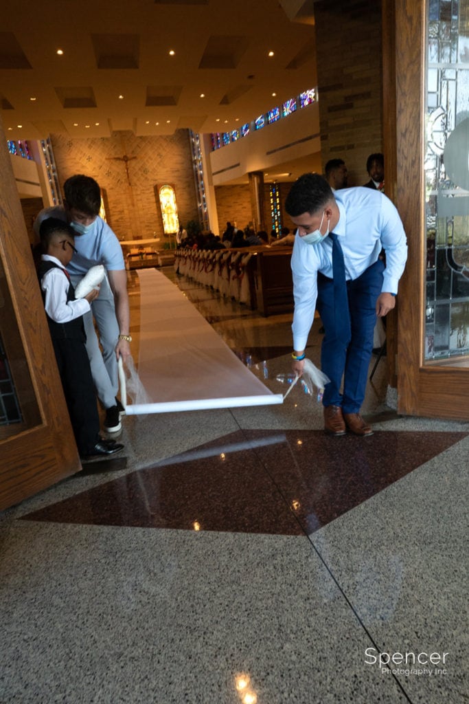 rolling out wedding aisle runner at st leo the great