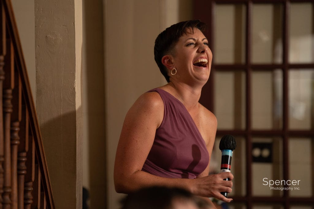 bridesmaid laughing during reception speech